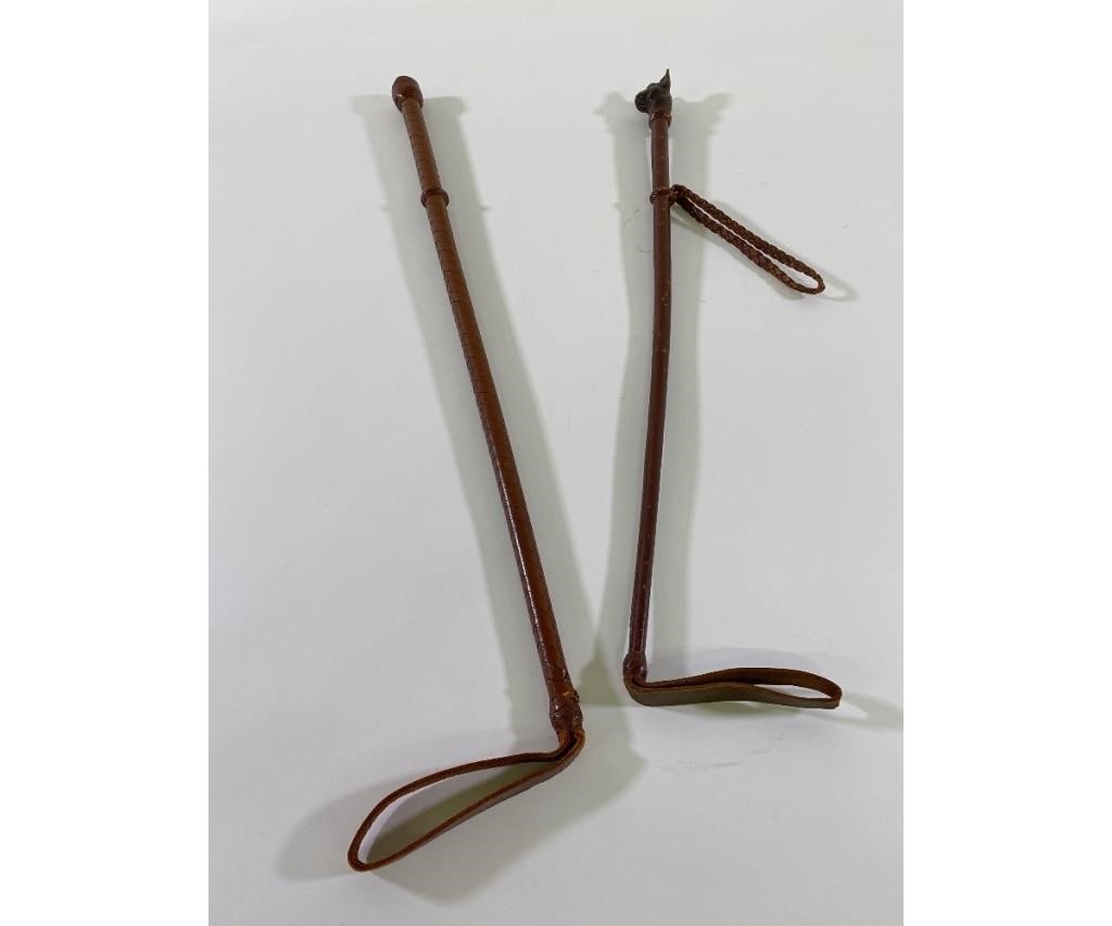 Two leather covered riding crops, one