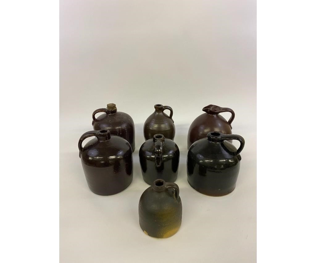Seven brown stoneware jugs, largest