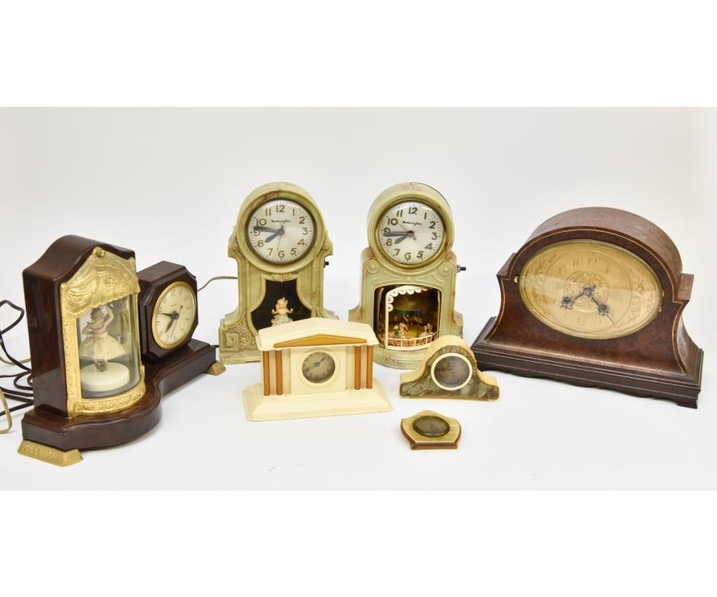 Seven wood/plastic/celluloid table clocks,