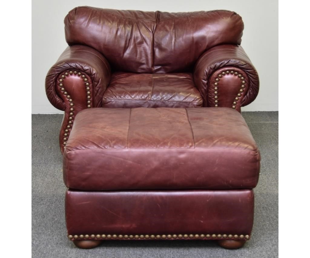 Red leather club chair with brass