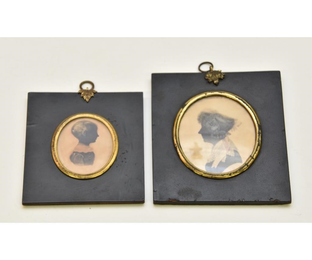 Two miniature oval watercolor silhouettes,