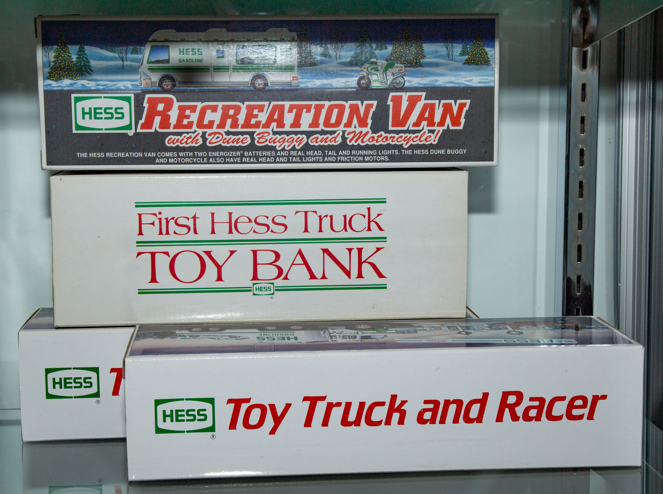 FOUR ASSORTED HESS TRUCKS Includes one