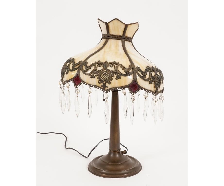 Ornate slag glass lamp with brass base,