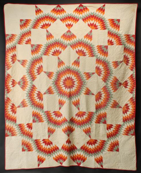 ANTIQUE QUILT IN THE 'BROKEN STAR'