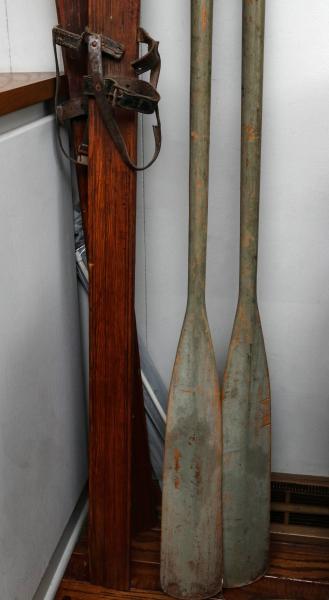 WOOD SKI PAIR AND BOAT OARS IN