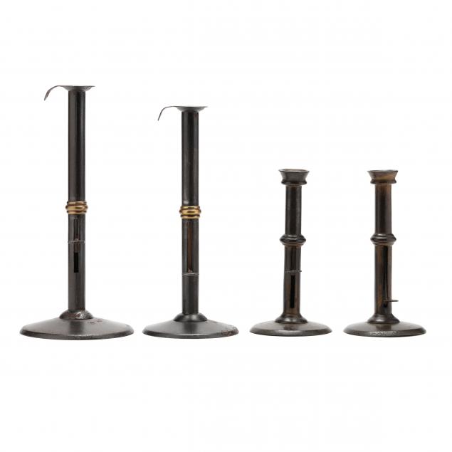 A GROUPING OF FOUR HOGSCRAPER CANDLESTICKS 28cc3e