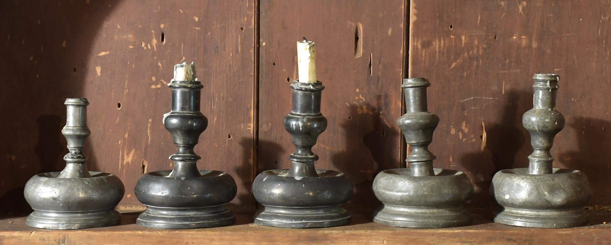 FIVE 17TH C. PEWTER CANDLESTICKS.