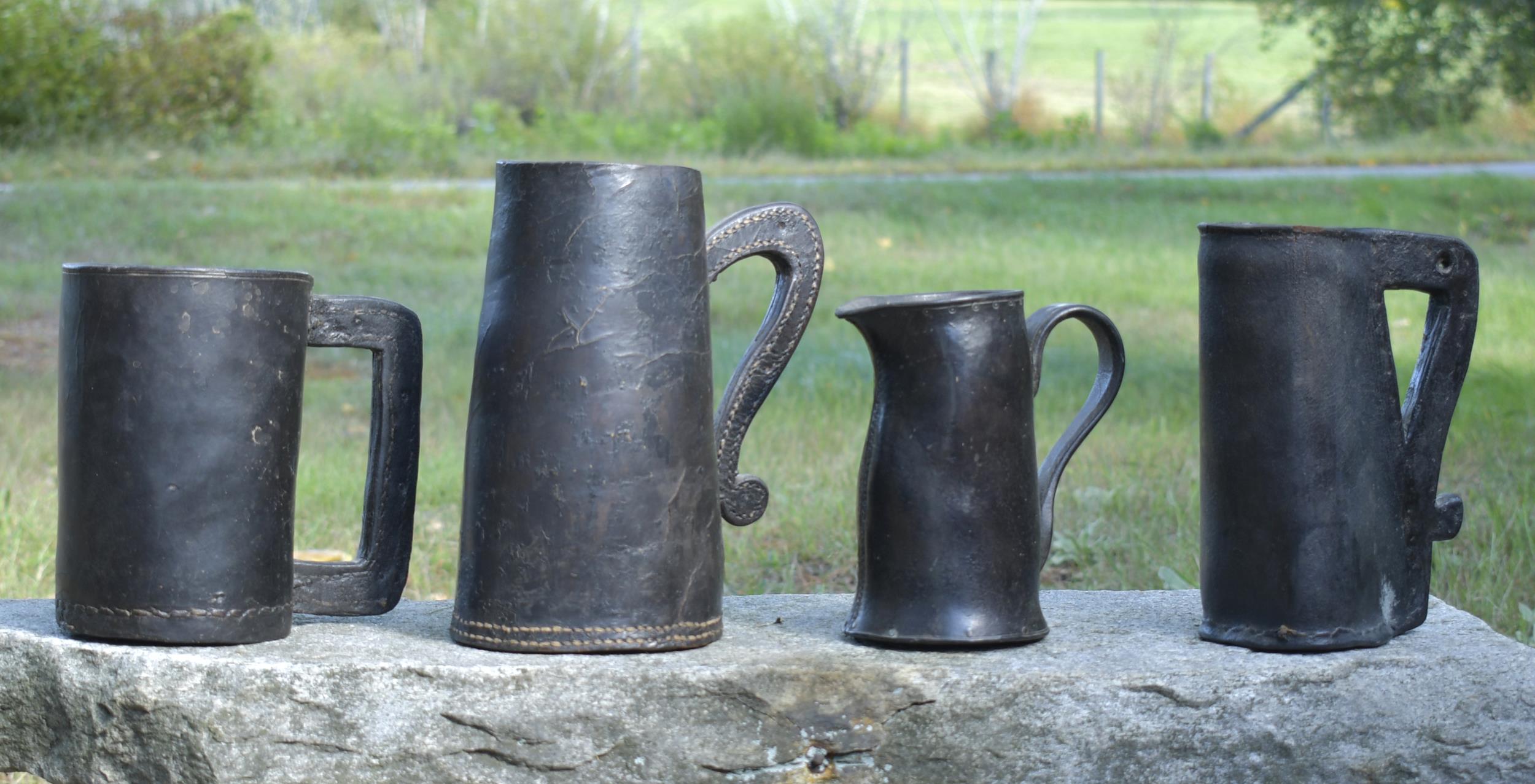 FOUR EARLY LEATHER TANKARDS 18th 29e233