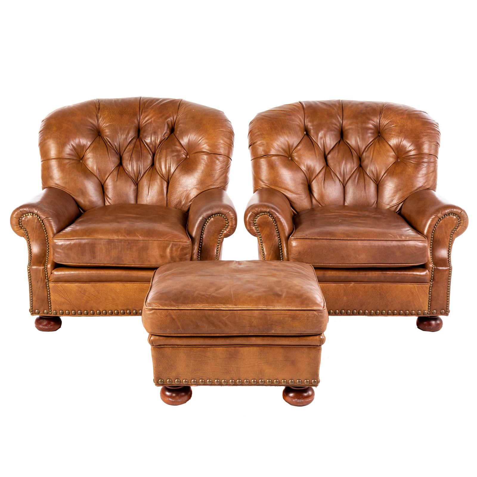 A PAIR OF TUFTED LEATHER ARM CHAIRS