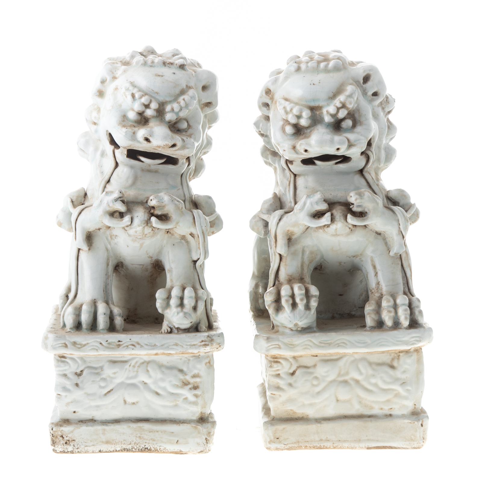 A PAIR OF CHINESE CELADON FOO DOGS Seated