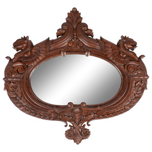 A Carved Mahogany Oval Mirror with