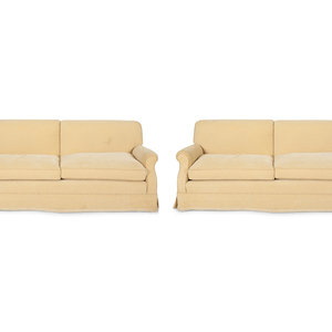 A Pair of Ivory Upholstered Three Cushion