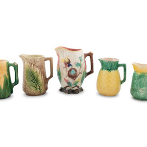 A Group of Nine Majolica Pitchers
includes