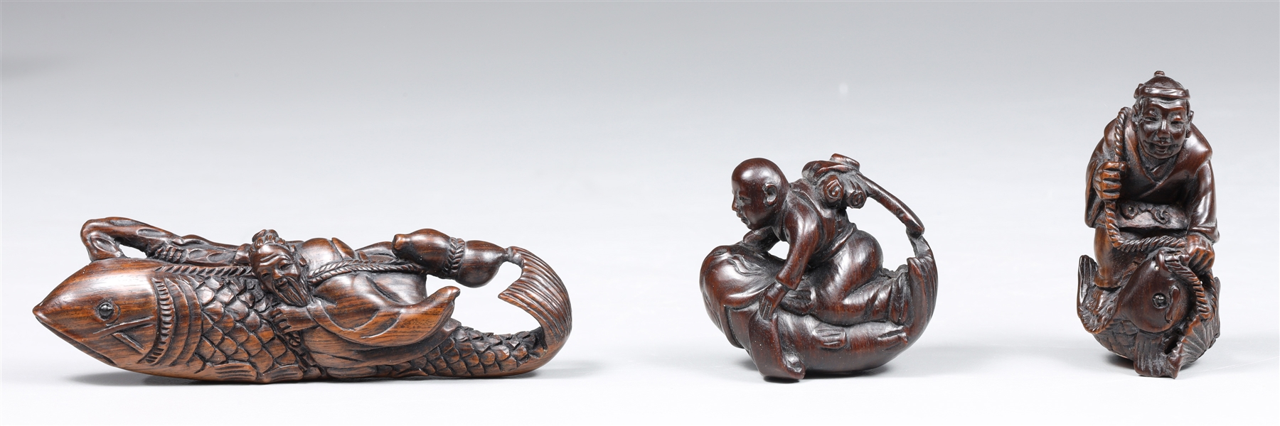 Group of three carved wood netsuke,