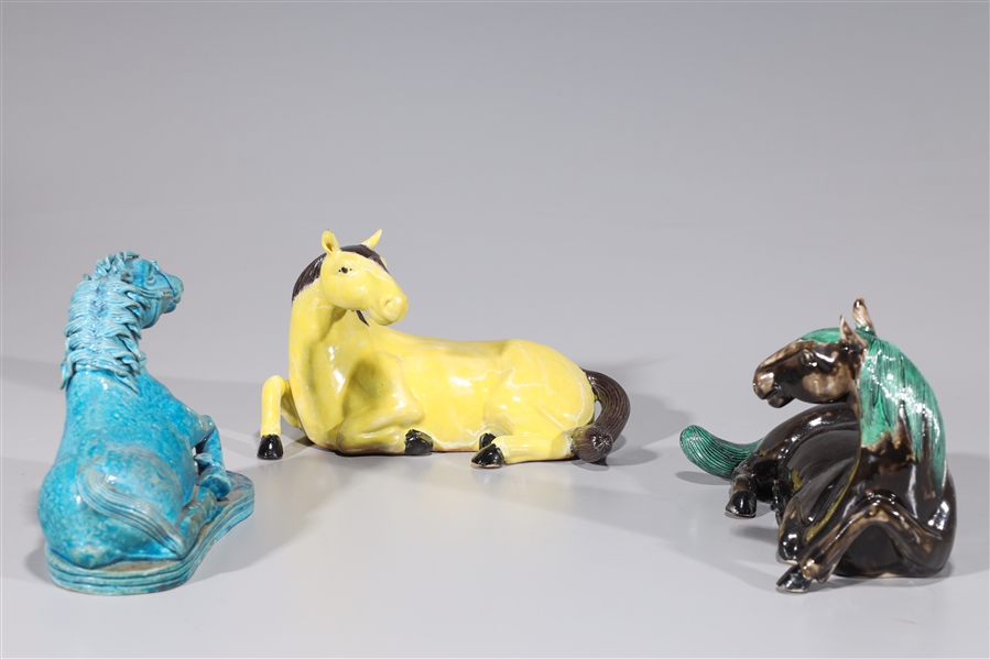 Group of three glazed ceramic horses,