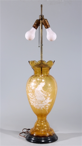 Large yellow glass vase with plant