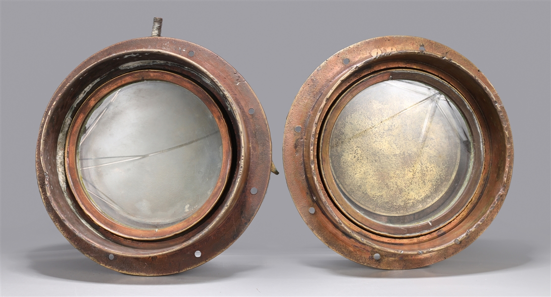 Two antique metal porthole covers,