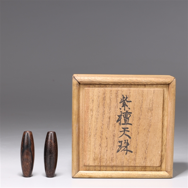 Two Chinese carved wood beads in