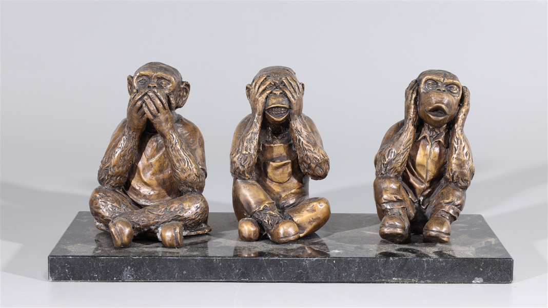 Three bronze monkey statues on