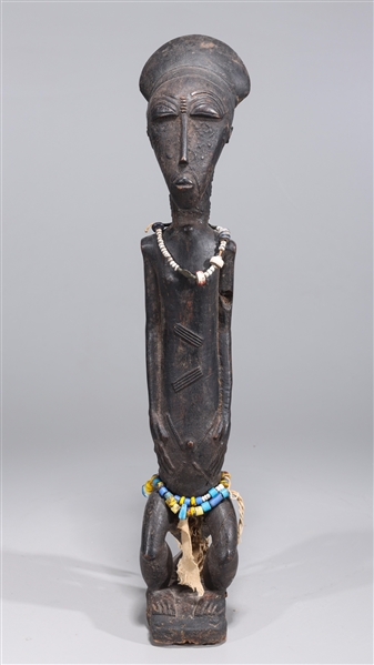 Wooden seated African figure with