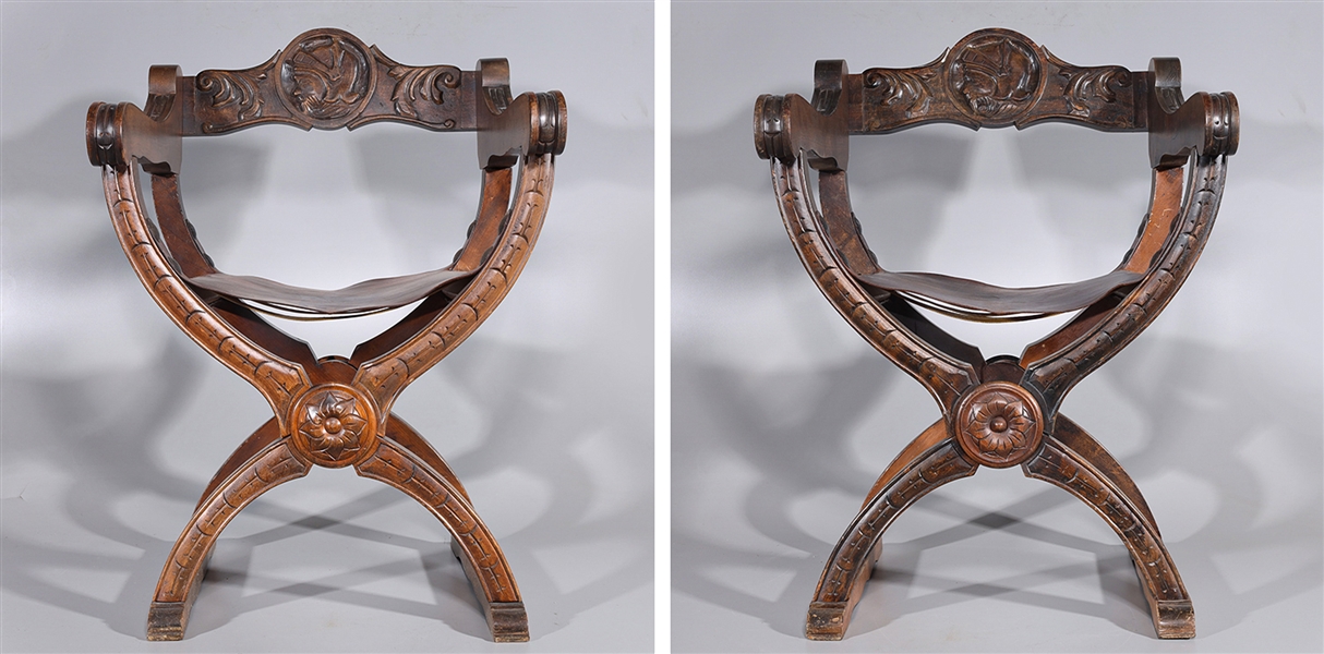 Pair of carved wooden folding chairs