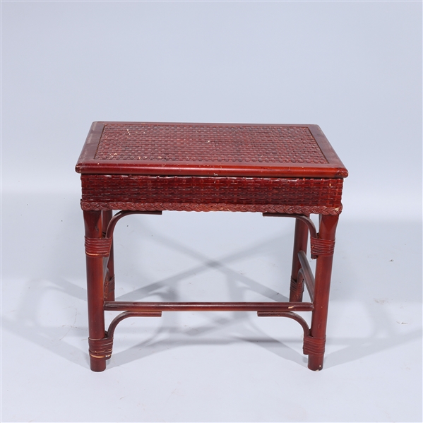 Small wooden bench with woven design;