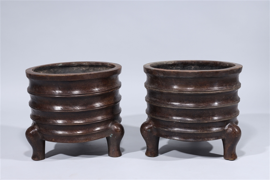 Pair of three-legged Chinese bronze