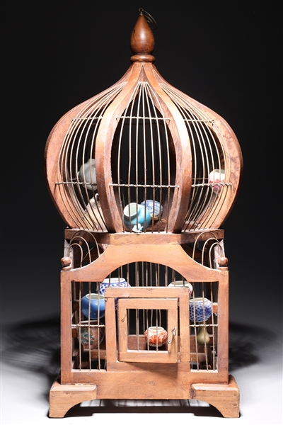 Antique bird cage sculpture with stuffed