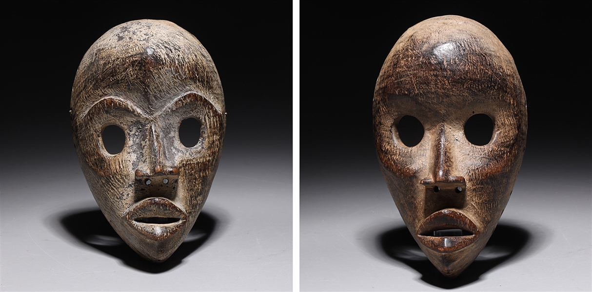 Two carved wooden masks in the