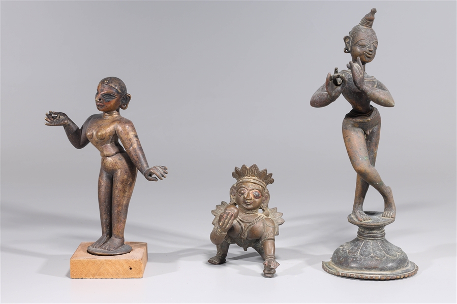 Three bronze cast statues of Krishna,