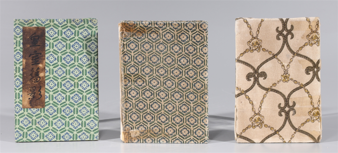 Group of three Chinese cloth-bound