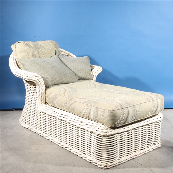 Wicker chaise lounge with cushions;