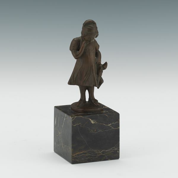 BRONZE FIGURINE OF A GIRL HOLDING
