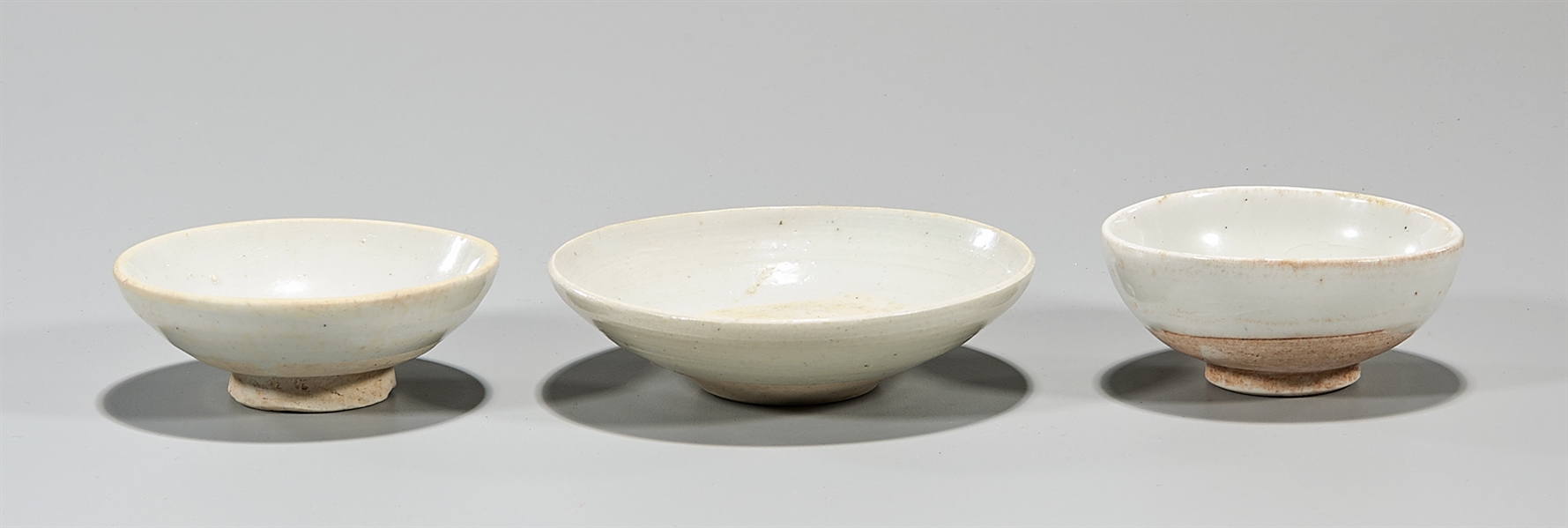 Three Chinese white glazed ceramic bowls;