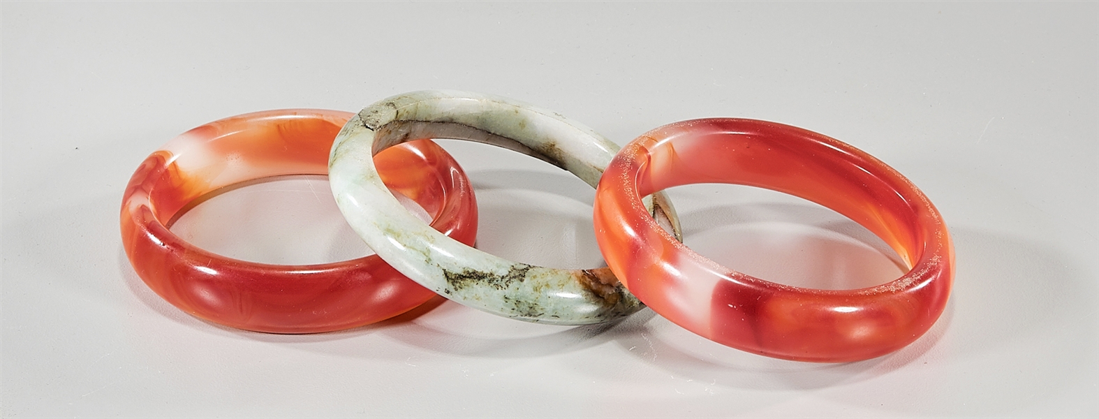 Three Chinese bangles; including