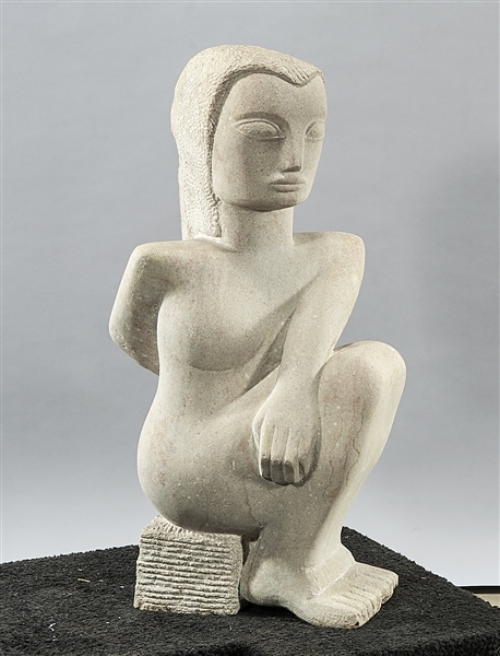 Gray stone sculpture of a reclining