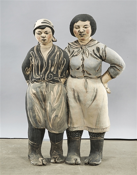 Painted stoneware sculpture of two women