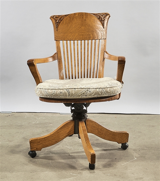 Wood swivel arm desk chair; partial