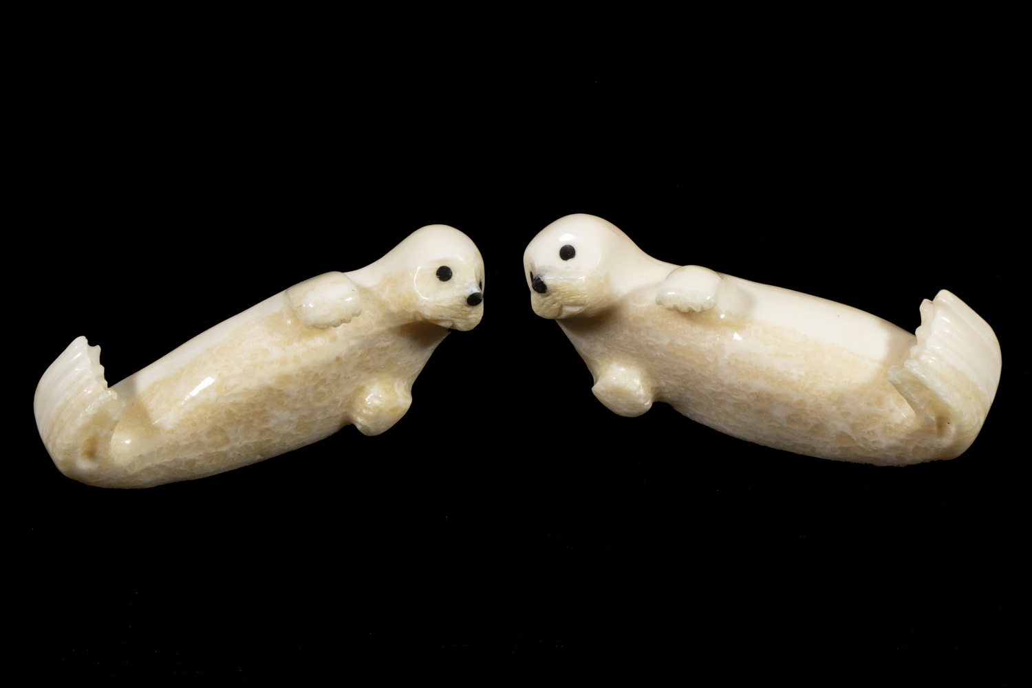 (2) INUIT SCULPTURES OF SEAL PUPS BY