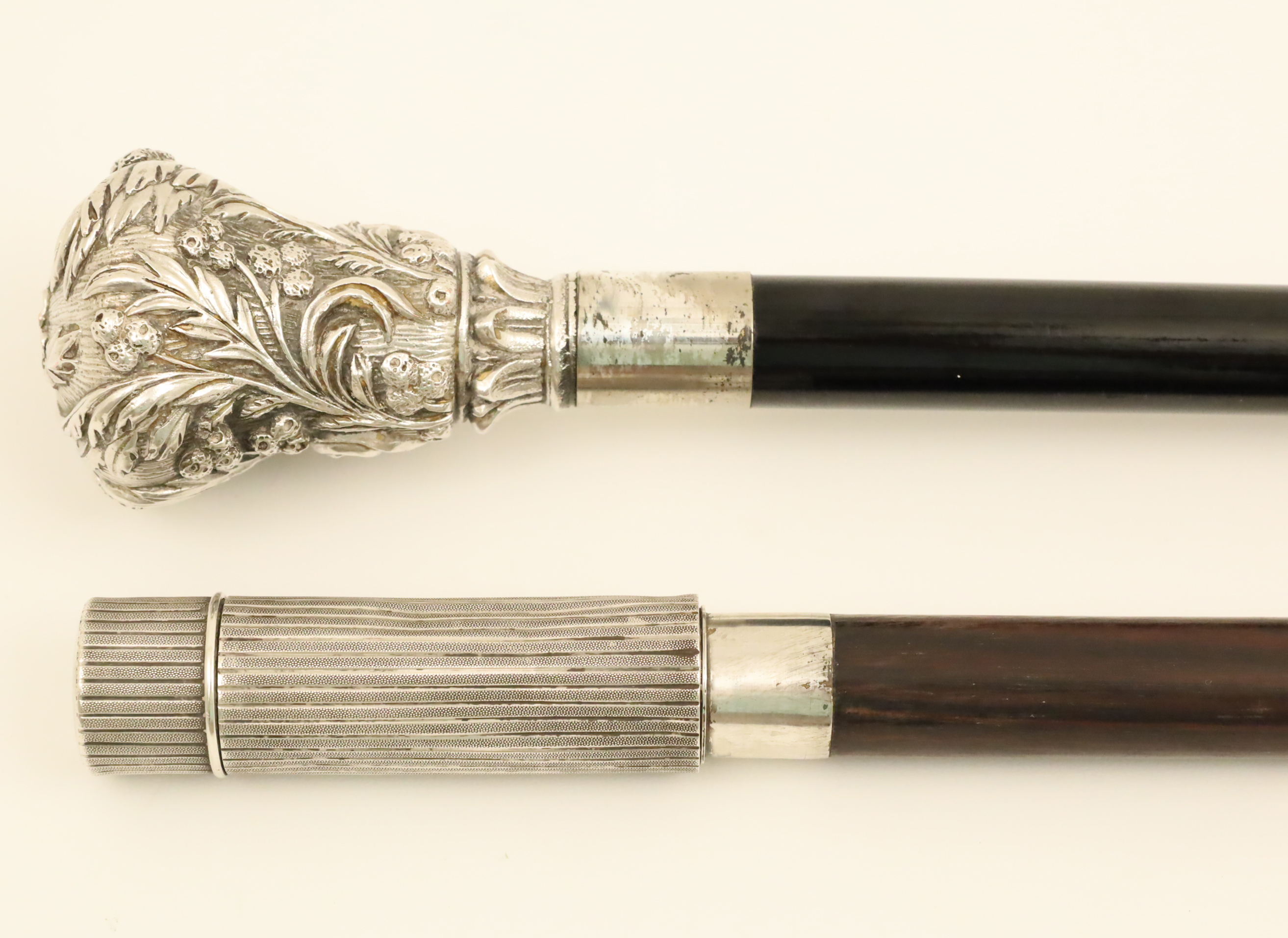 TWO STERLING HANDLE WALKING CANES