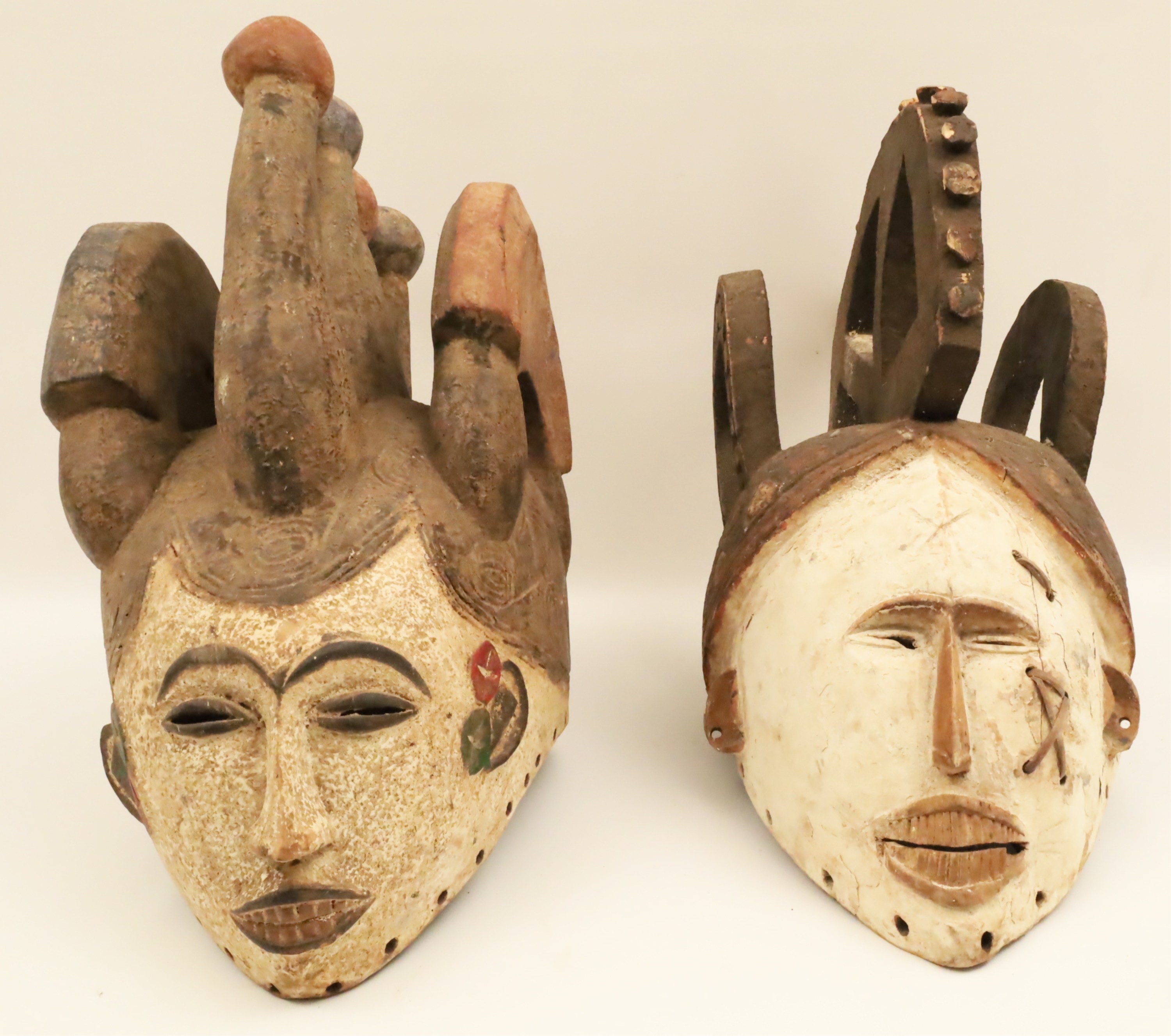 TWO AFRICAN TRIBAL MASKS Both carved 2b7ac0