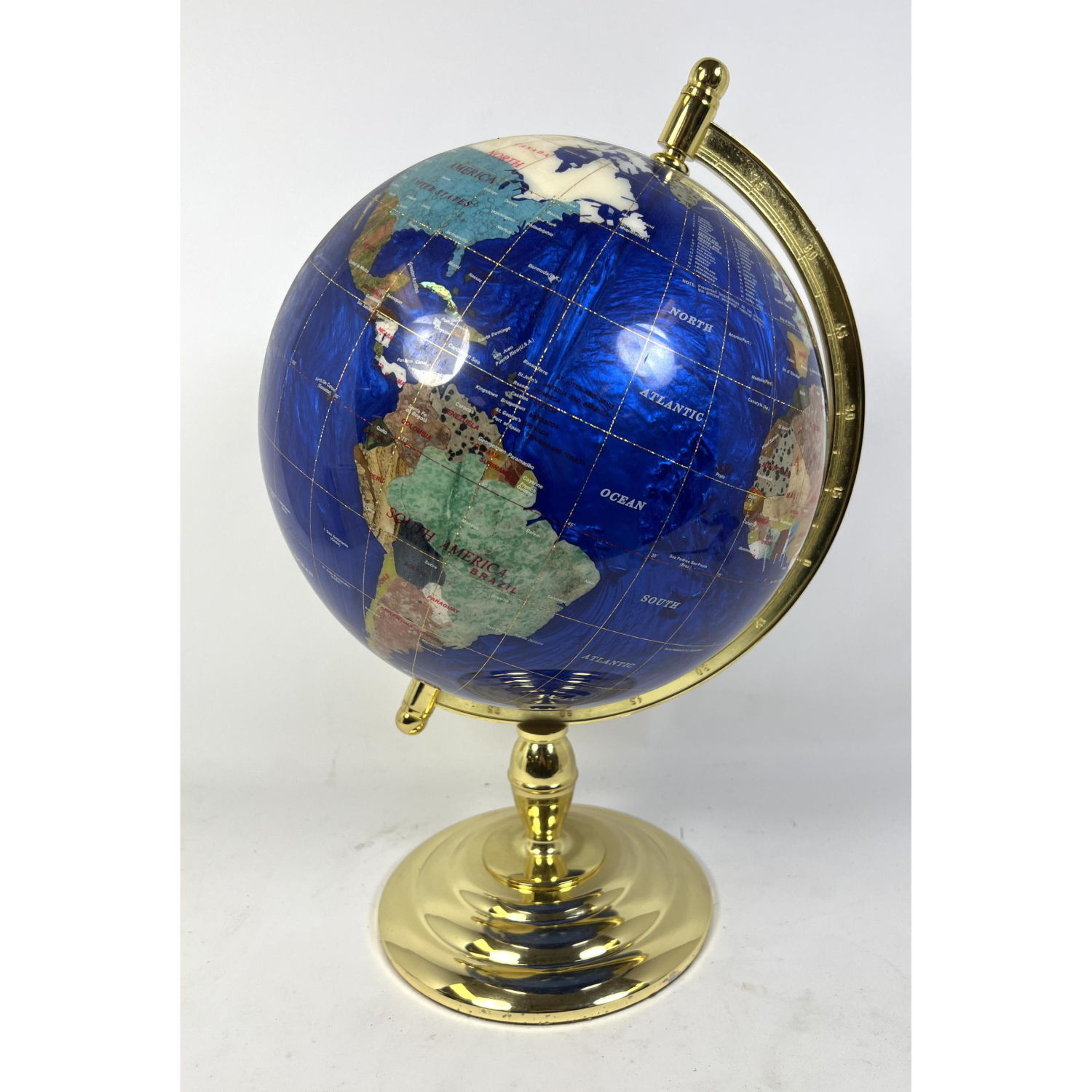 Stone inlay table top globe. Brass