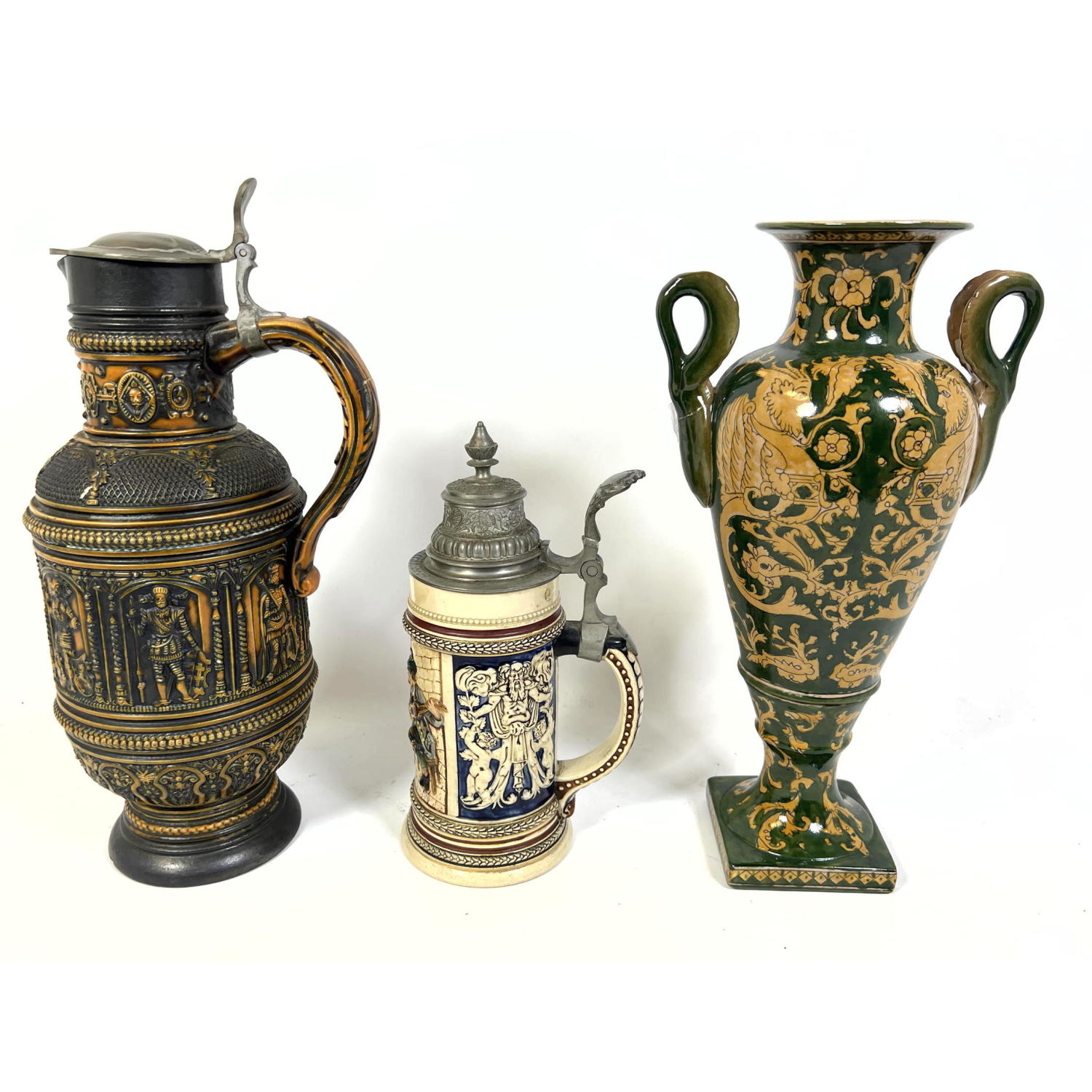 Two Pottery Steins. One Tall Handled