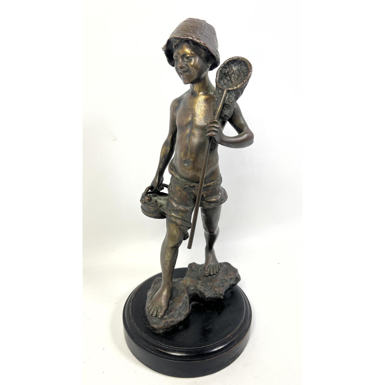 Bronze sculpture of boy with fishing