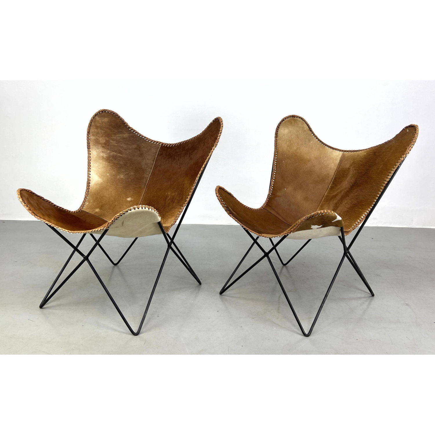 Pair of butterfly chairs with cowhide