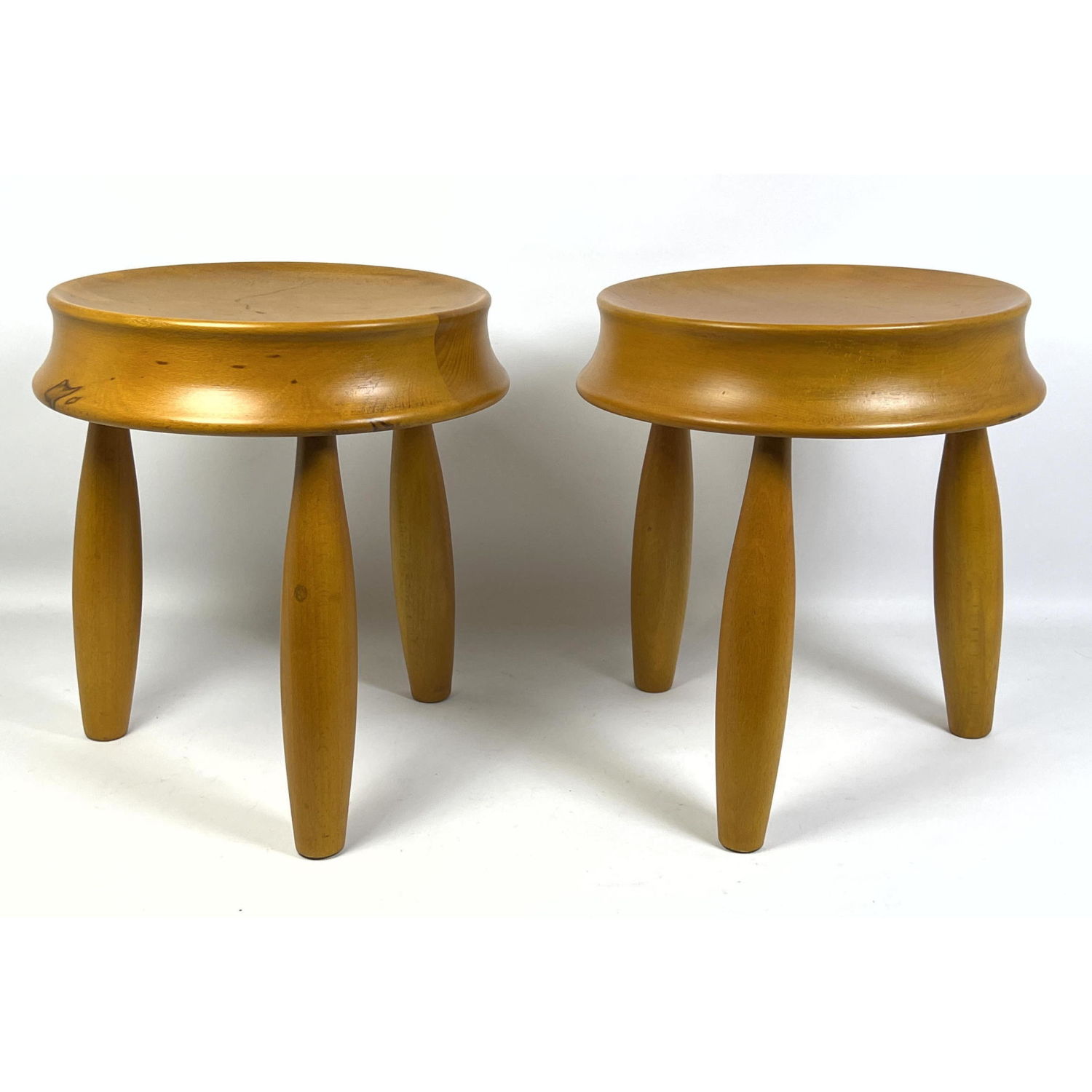 A pair of wood stools in the manner