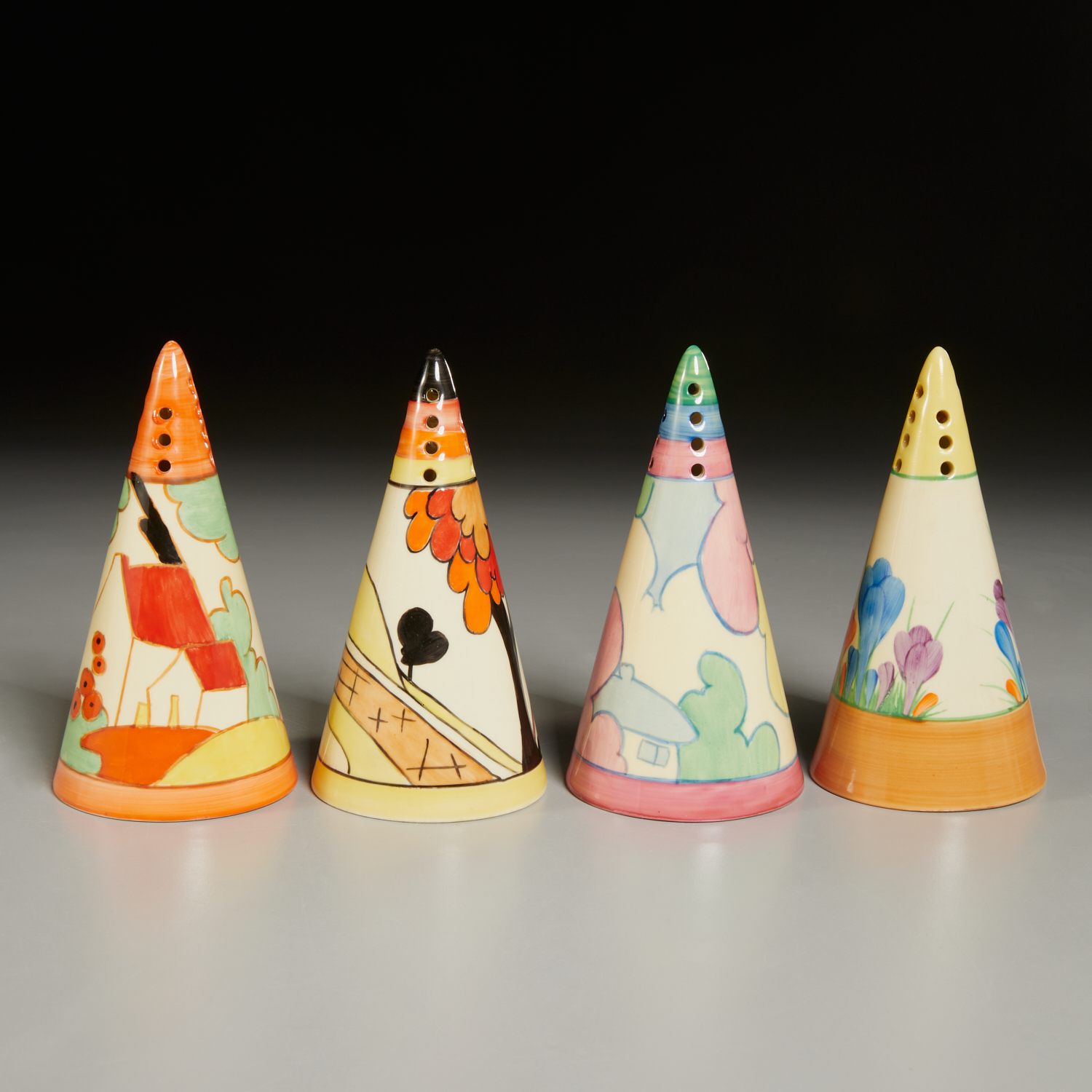 CLARICE CLIFF, FOUR STAFFORDSHIRE SHAKERS