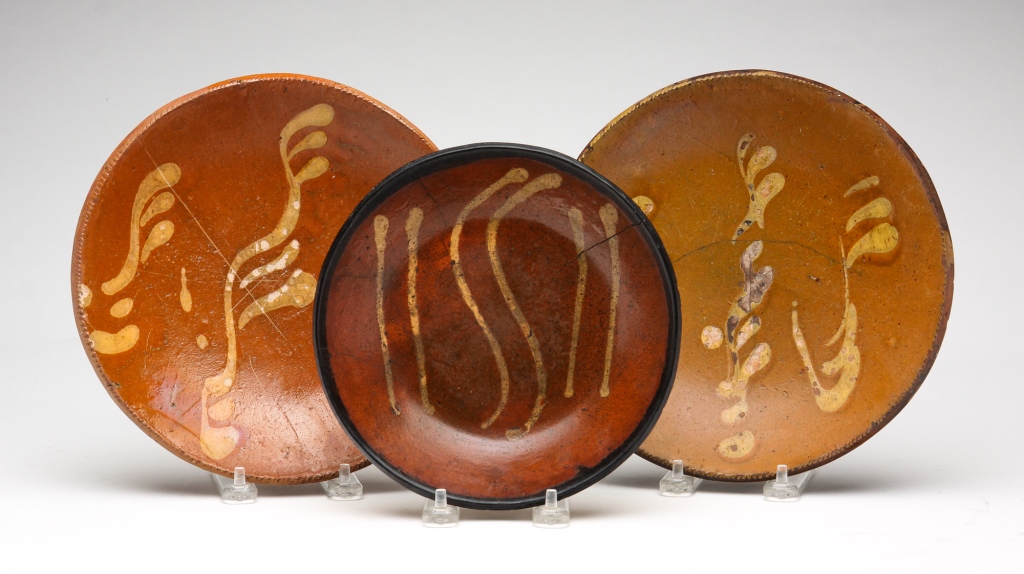 THREE AMERICAN REDWARE PLATES. First