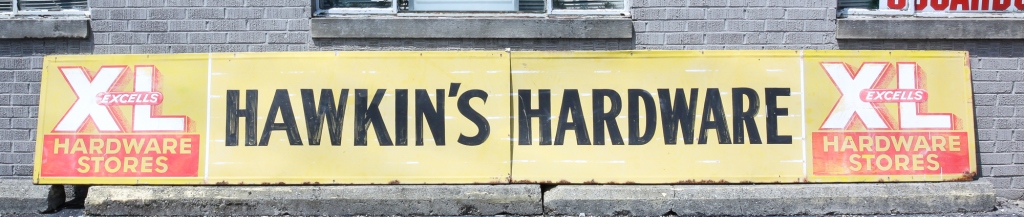 TWO AMERICAN EXCELLS HARDWARE SIGNS.