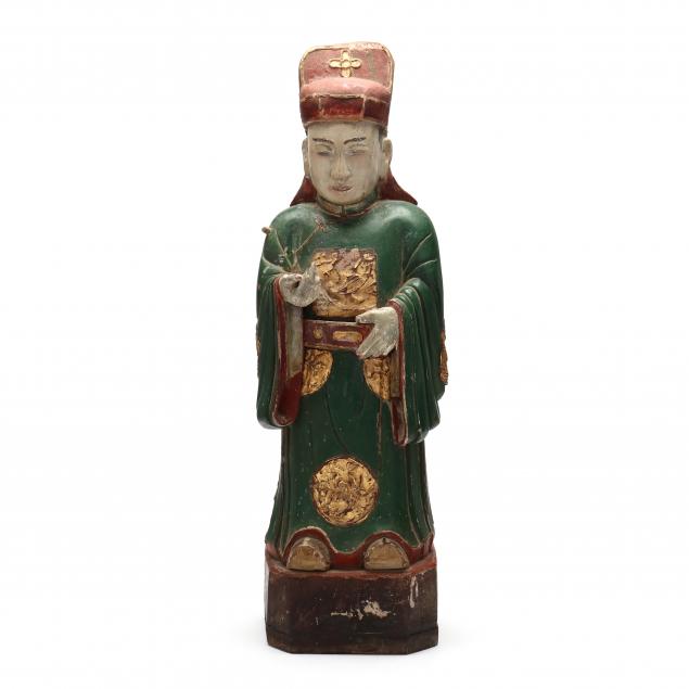 A CHINESE CARVED WOODEN FIGURE OF AN